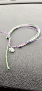 A close up of a bracelet with a tag