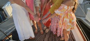Group of people showing their hands and feet together in a circle.